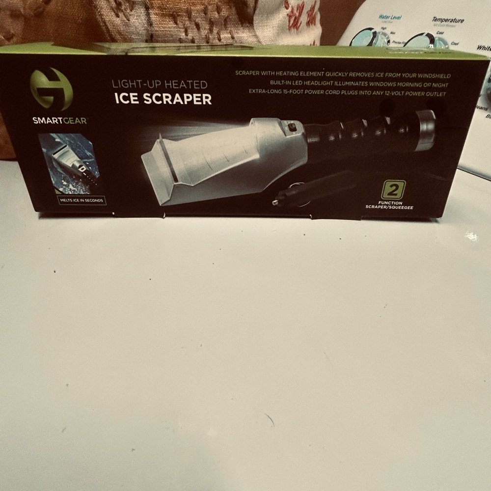 Heated ice scraper